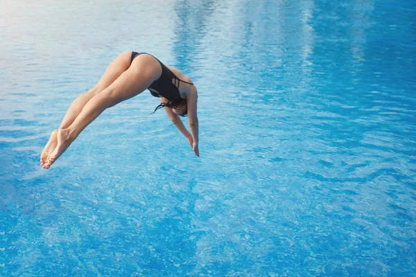 Girl jumps naked into pool photo