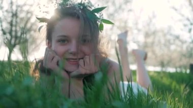 Güzellik gülümseyen kız bahar çayır kır çiçekleri ile yalan. Gülmek ve mutlu. Doğa keyfini çıkarın. Güzel genç kadın açık havada.