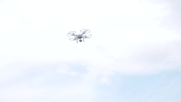 Modern RC UAV Drone quadcopter with camera flying in sky — Stock Video