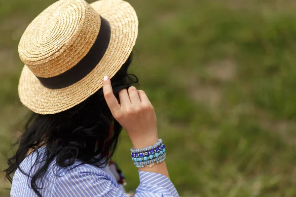 shoot from back of woman hold her hat