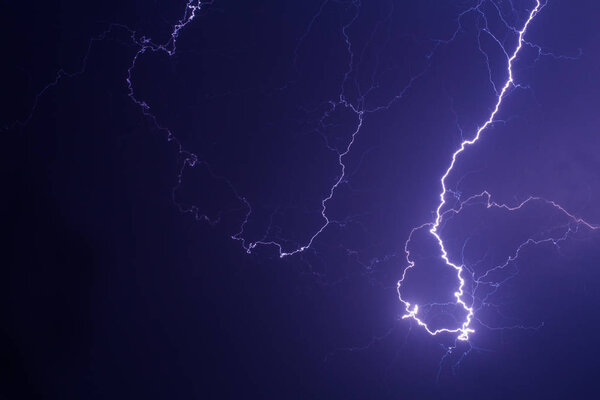 Lightning storm over the city in purple light