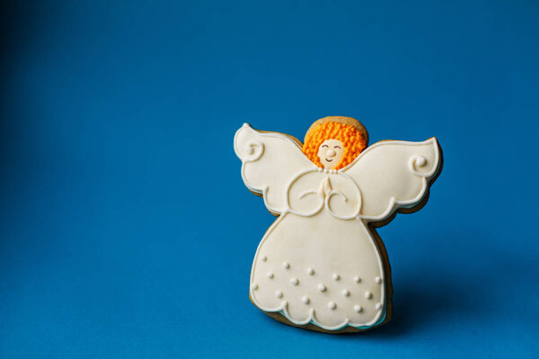 Рождественский новогодний фон, ангельские пряники печенье на синем фоне. Копирование пространства
.