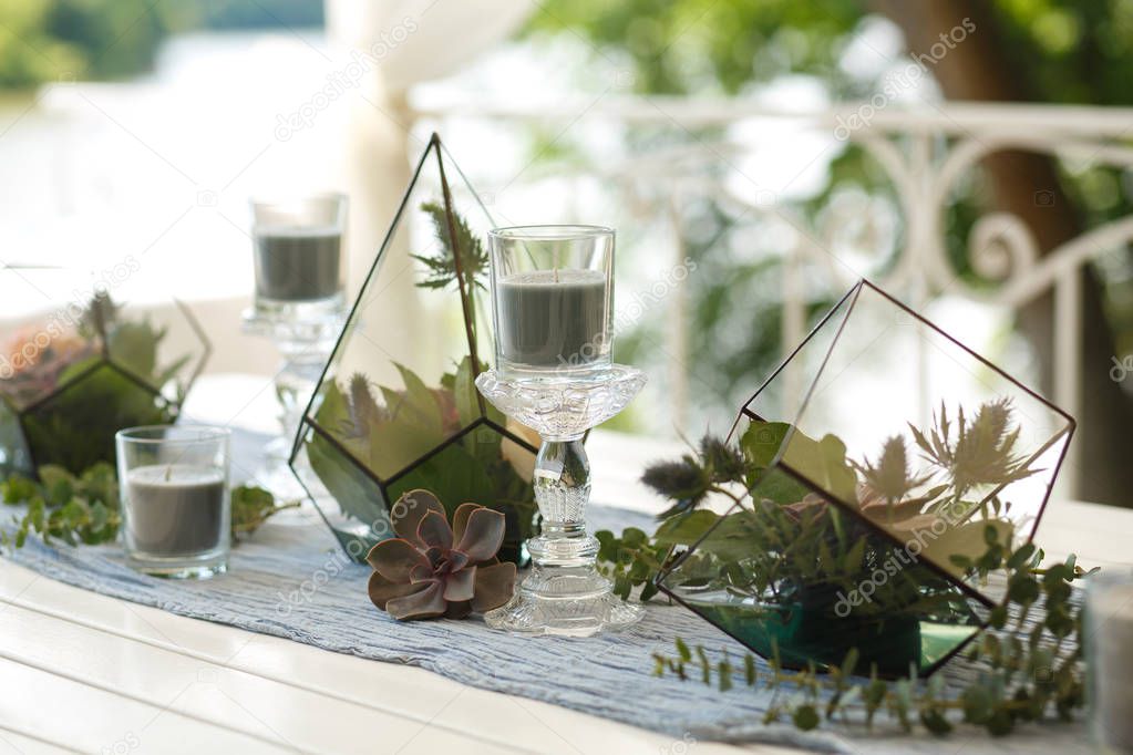 Florarium with fresh succulent and rose flowers festive table decoration. Event fresh flowers decoration. Florist workflow. Wedding ceremony design.