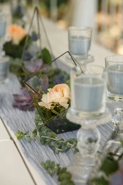 Florarium with fresh succulent and rose flowers festive table decoration. Event fresh flowers decoration. Florist workflow. Wedding banquet design.