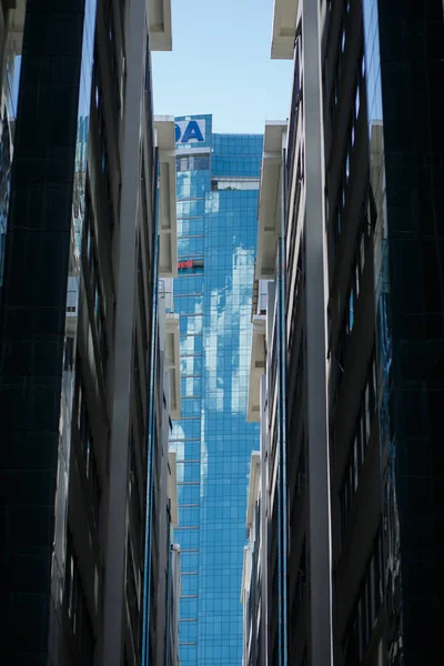 Looking on full glass building between two office buildings in downtown KL.