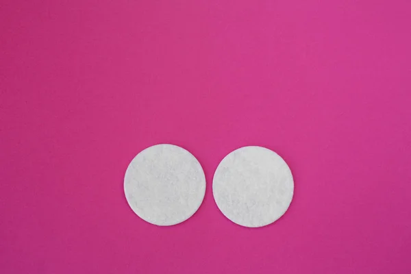 Felső nézet fehér kerek pamut lemezek meghatározott rózsaszín háttér — Stock Fotó
