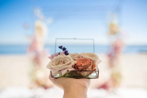 closeup woman hands hold glass box for wedding rings decorated w
