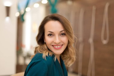 Portrait of gorgeous woman yoga trainer posing in for yoga class clipart