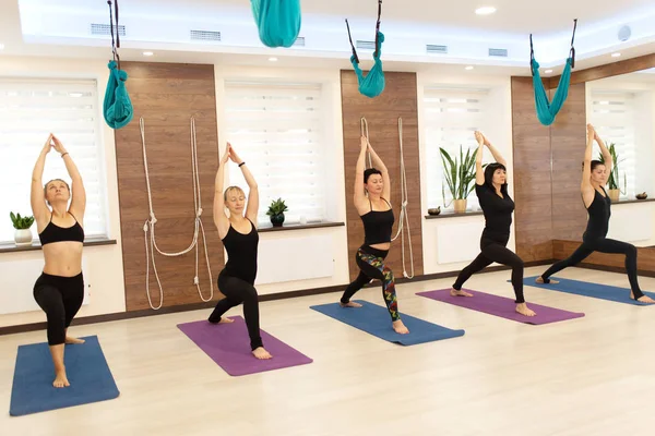 Group of womans doing yoga exercises in gym. Fit and wellness li — Stock Photo, Image