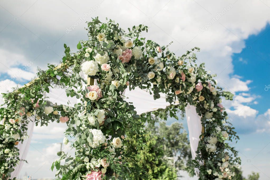 A festive chuppah decorated with fresh beautiful flowers for an 