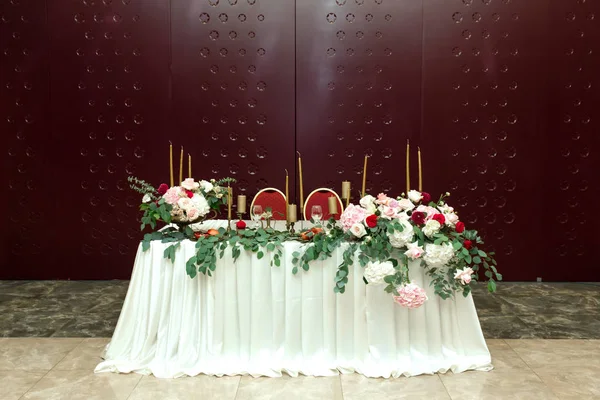 Nygifta bankett bord dekorerad med färska blommor vid bröllopsceremonin — Stockfoto