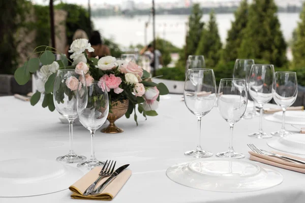 真鍮のvaで新鮮な花で飾られた結婚式のテーブルの設定 — ストック写真