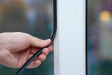 Pencerelerin onarımı ve kurulumunda profesyonel usta, pvc pencerelerindeki lastik contaları değiştirir.
