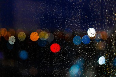 Pencerelere su damlaları ve günbatımında şehir batımları.