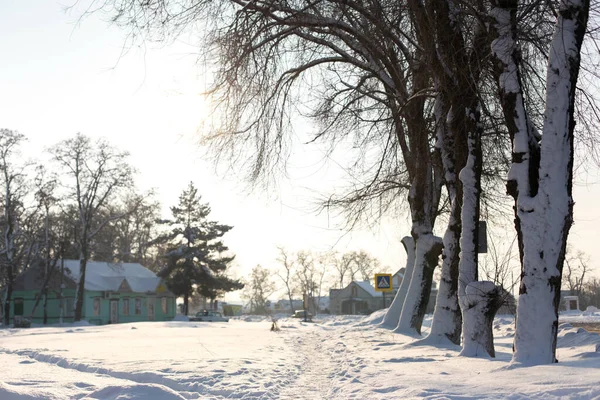 Winter poorly cleared road. Road in the countryside strewn with snow. Winter landscape with snowdrifts.