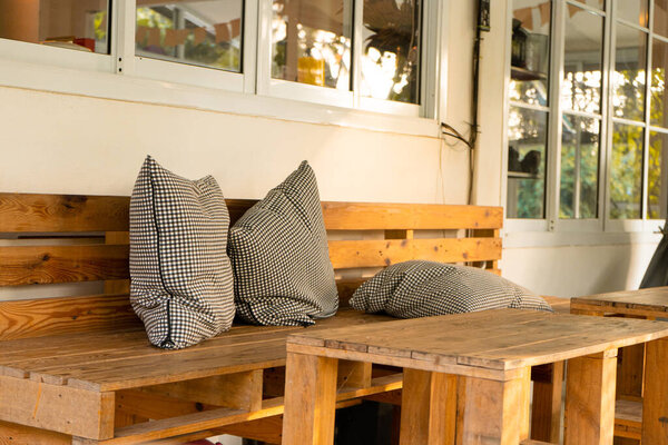 Cafe interior with furniture from pallets and checkered pillows