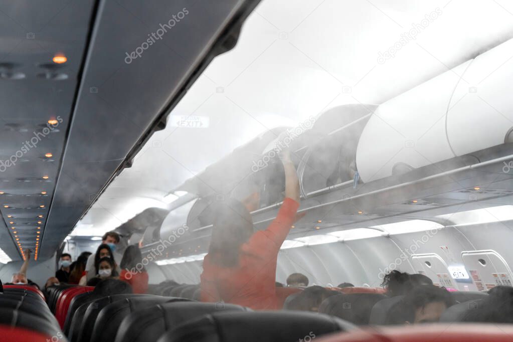 The aircraft cabin before departure. Boarding passengers. Air travel during the coronavirus pandemic
