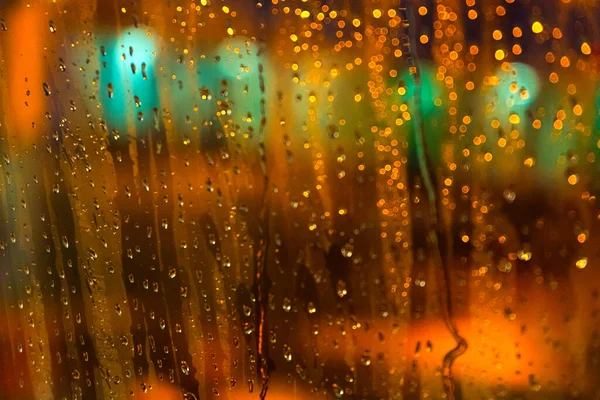 The view from the plane window of the night airport during heavy rain. Selective focus. Blurred image.