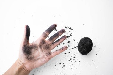 Kül içinde eski bir ördek yumurtası tarifi. Beyaz arka planda kül içinde tuzlu ördek yumurtası. Bir yumurtayla küle bulanmış bir el.