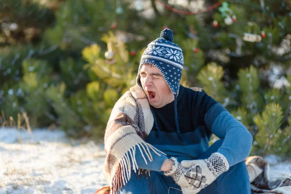 Guy Yawns While Sitting Winter Forest Wrapped Warm Cozy Plaid — Stock Photo, Image