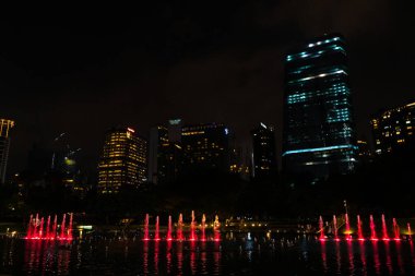Night view of the dancing multi-colored fountains. Show of Singing Fountains. Kuala Lumpur, Malaysia - 07.18.2020