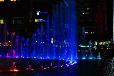 Night view of the dancing multi-colored fountains. Show of Singing Fountains. Kuala Lumpur, Malaysia - 07.18.2020