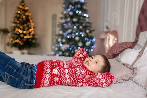 Happy Little Boy Red Knitted Sweater Dream Presents Laying Bed — Stock Photo, Image