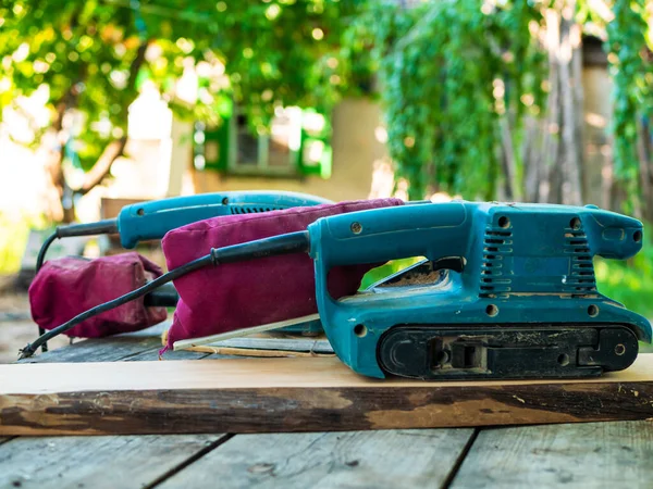 Wood processing. Two grinding machines on a board — Stock Image Wood Processing Two Grinding Machines Board Stock Photo