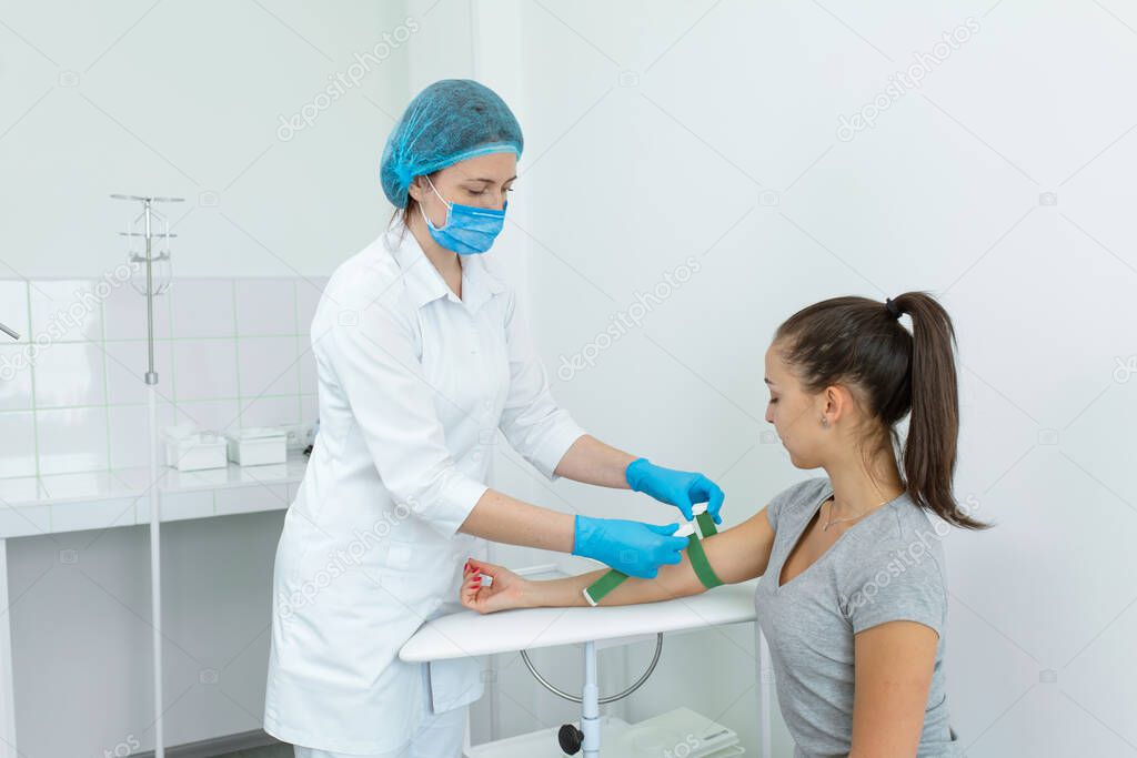 the nurse fastens the clip on the patients hand before the blood sampling procedure.