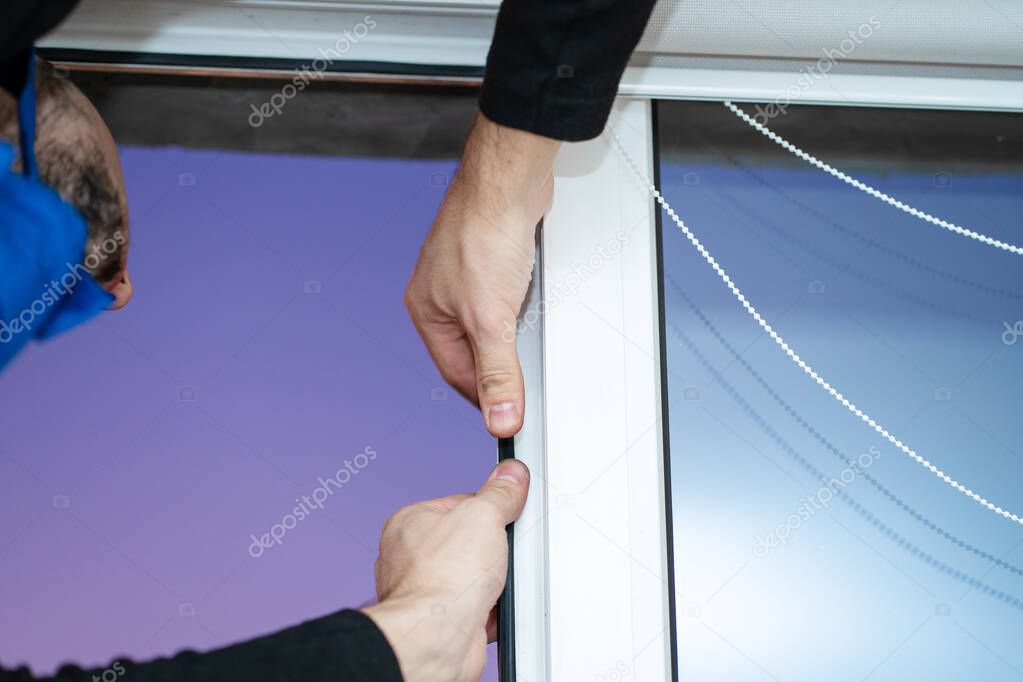 Professional master at repair and installation of windows, changes rubber seal gasket in pvc windows.