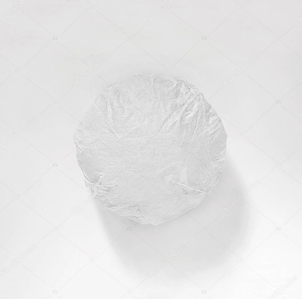 Classic burger packed in the wrapping paper on white background. Top view.