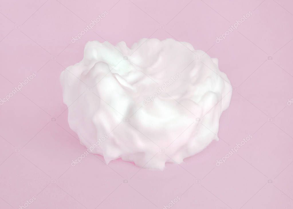 Gentle cosmetic white cream on pastel pink background.