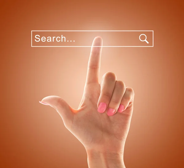 The index finger of a female hand points to the search field