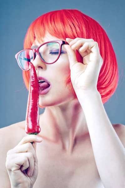 Tricky Beauty Woman Red Wig Eyeglasses Licking Chili Pepper — Stock Photo, Image