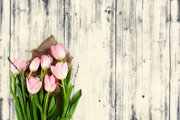 A spring tulips on wood background — Stock Photo, Image