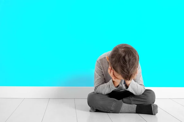 Un niño cuya depresión está sentado en el suelo — Foto de Stock