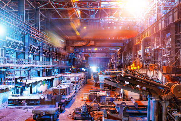 Interior of metallurgical plant industrial workshop with open hearth furnace and heavy industry manufacturing equipment