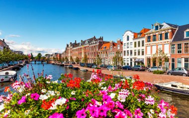 Scenic summer view of the Old Town architecture and Spaarne canal embankment in Haarlem, Netherlands clipart