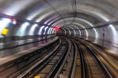 Riding the train in subway metro underground tube tunnel illuminated railroad track with motion blur effect clipart