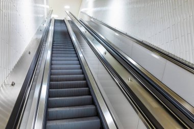 Moving staircase or escalator to the metro subway underground station clipart