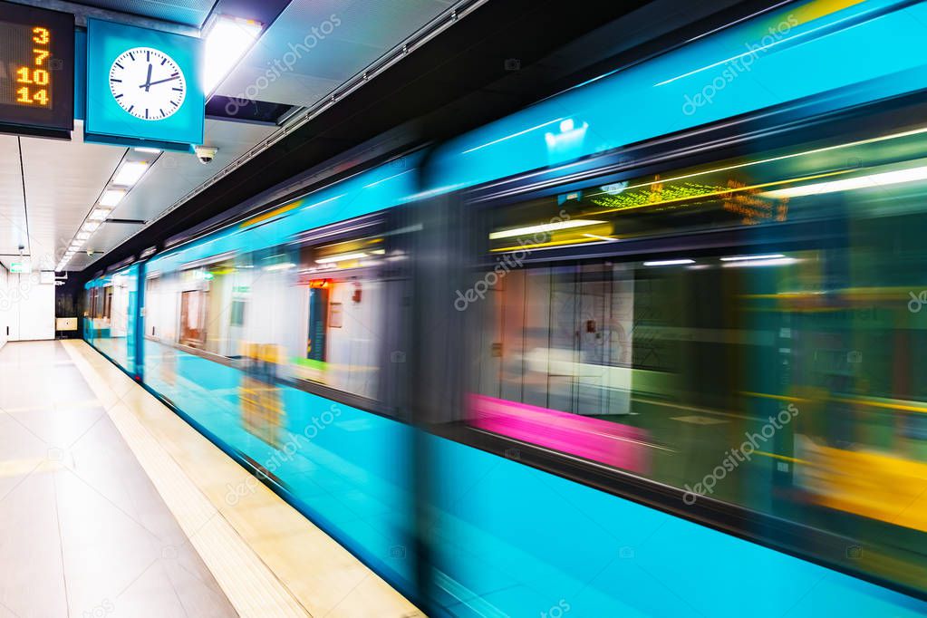 Creative abstract commuter city business travel transportation concept: subway underground metro train at railway station platform with high speed motion blur effect