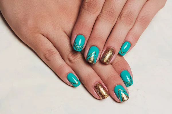 Summer nail art in turquoise and gold colors