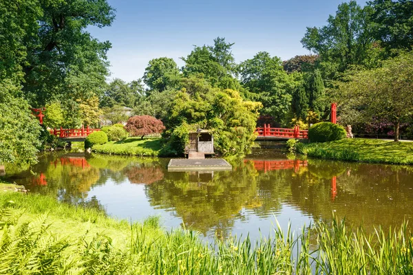 ハンブルク ドイツのハーゲンベック動物園で赤の木製の橋のある風景します — ストック写真