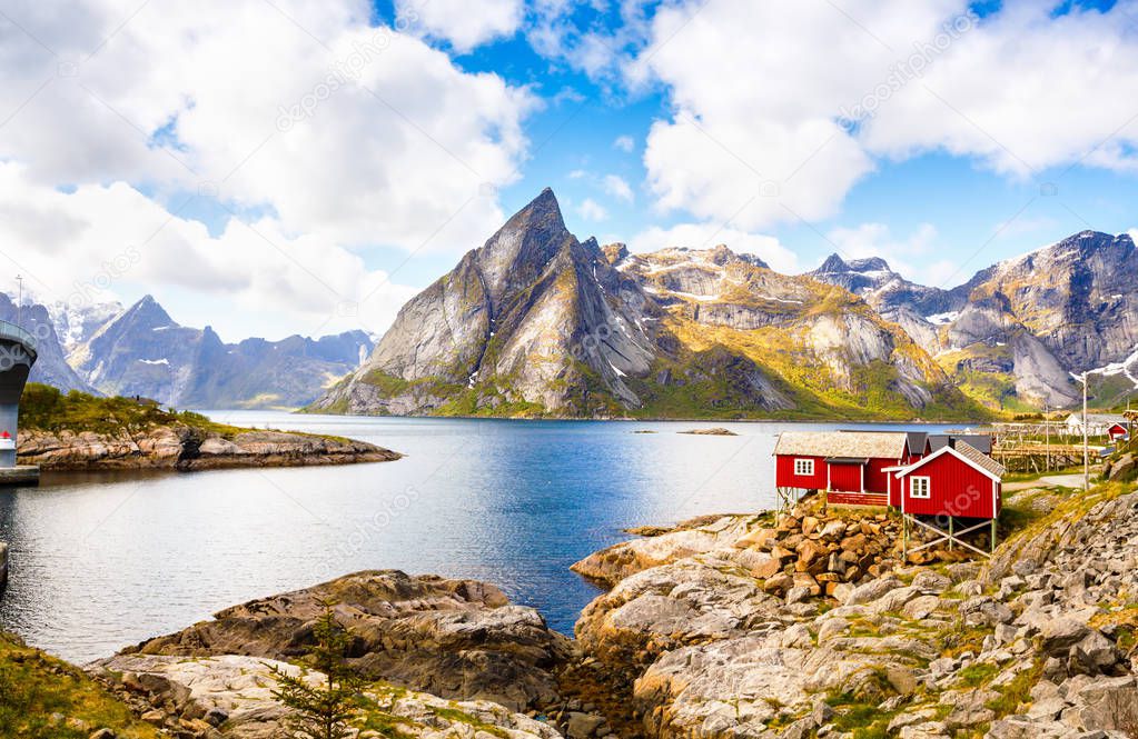 Landscape with high rocky mountains, traditional houses and fjord in Hamnoya, Norway.