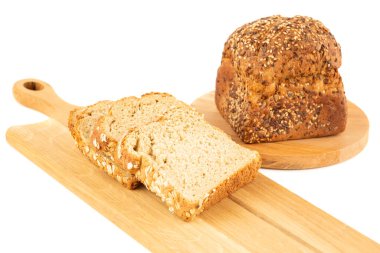 Tohumlu kepekli ekmek ve beyaz arka planda tahtadan yapılmış yulaf..