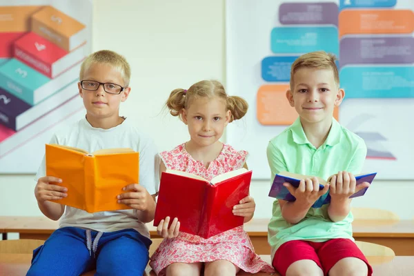 Three Schoolchildren Reading Books Classroom School — Stock Photo, Image