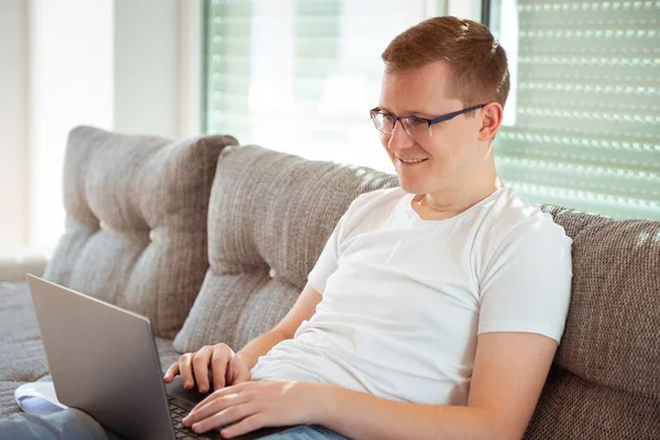 Giovane che lavora con il computer portatile a casa — Foto Stock