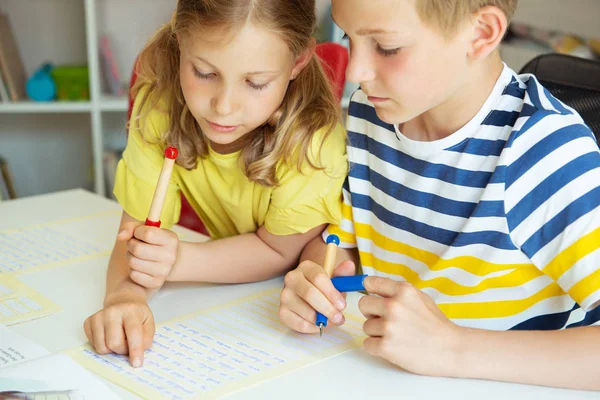 Cute clever schoolchildren are came back to school and studying Stock Photo