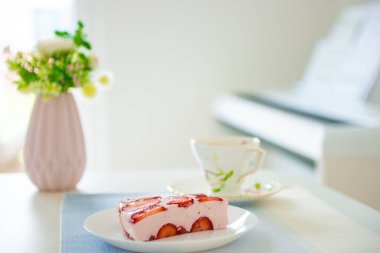 Bir masada çilek ile Taze cheesecake