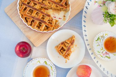 Taze pişmiş elmalı turta, bir masada çay ve çiçek fincan 